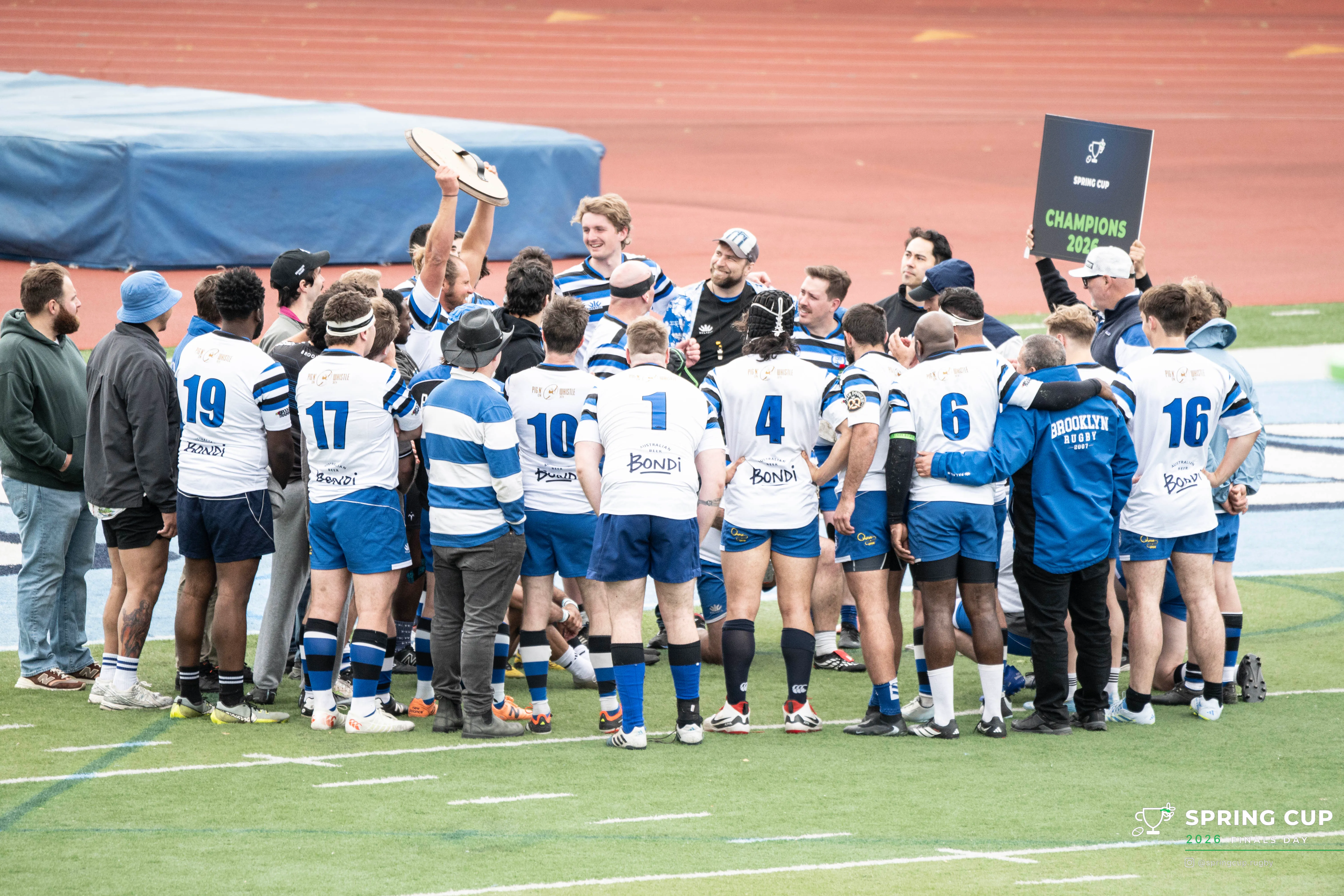 Brooklyn Rugby Club huddle around the Spring Plate after their final win
